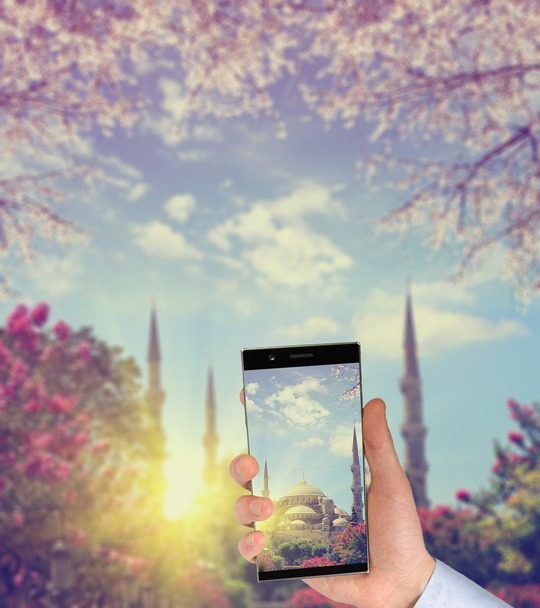 Tourist taking a picture in front of The Blue Mosque at spring, Istanbul, Turkey - Photo, Image