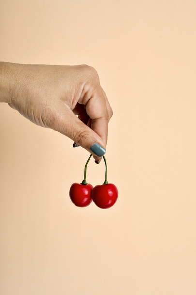 young woman holding some fake cherries - Photo, Image