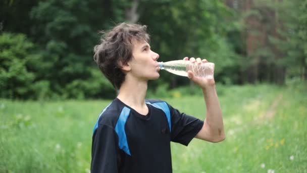 Man drinking water in the summer forest - Footage, Video