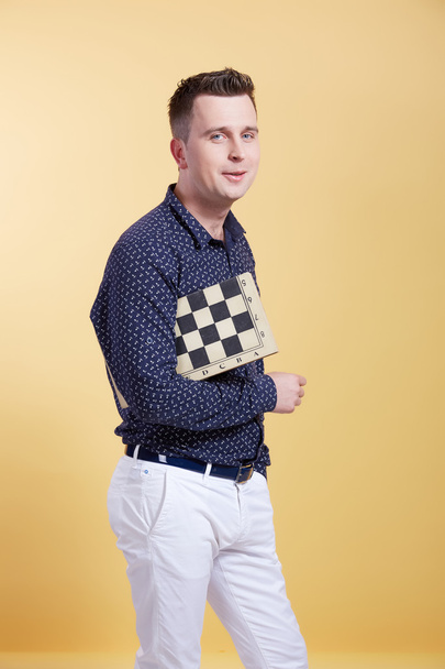 Young man with chessboard  - Fotó, kép