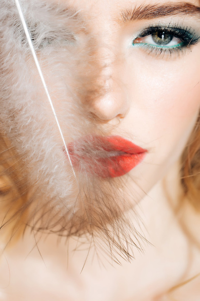 Pretty woman with feather closeup - Фото, зображення