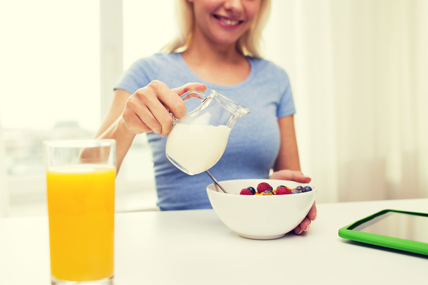 close up of woman with milk jug eating breakfast - Photo, Image