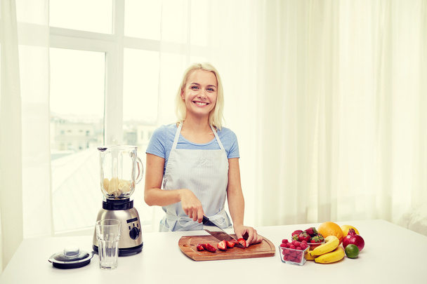 smiling woman with blender preparing shake at home - Φωτογραφία, εικόνα
