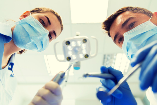 close up of dentist and assistant at dental clinic - Foto, immagini