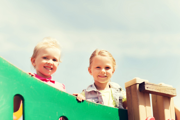 happy little girls on children playground - Фото, зображення