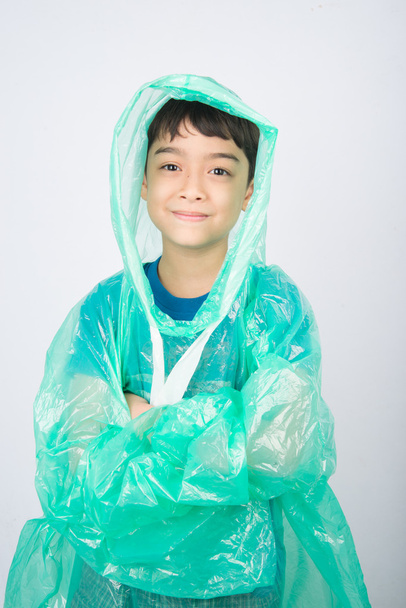 Kisfiú eső kabátot visel fehér háttér - Fotó, kép