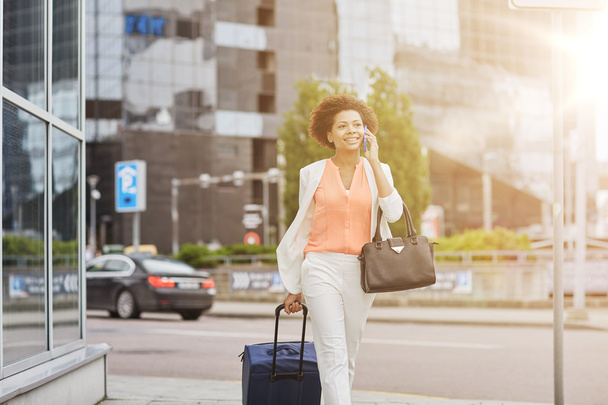 happy woman with travel bag calling on smartphone - Фото, изображение