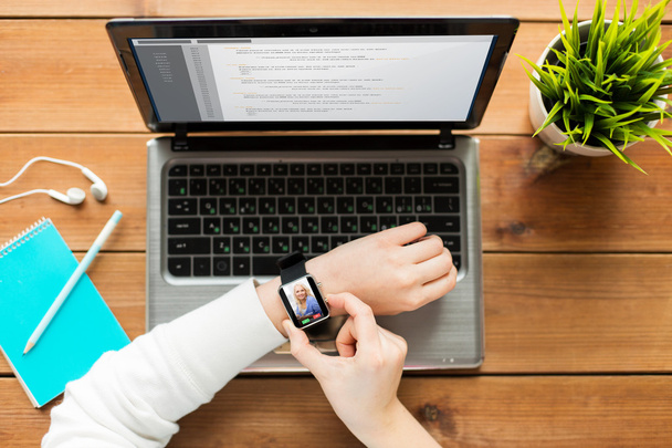 close up of woman with smart watch and laptop - Foto, Bild