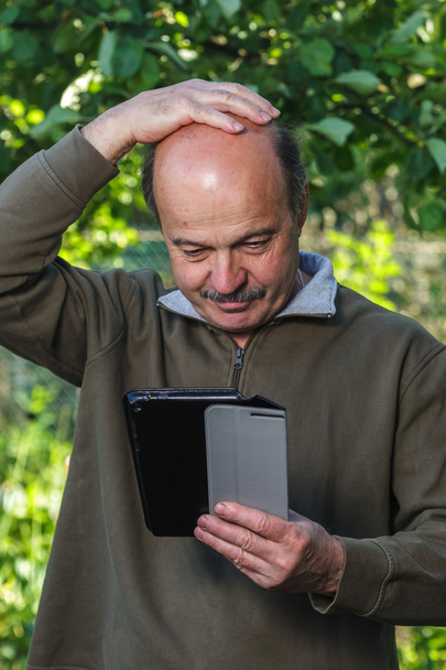 Hombre de edad avanzada no puede hacer frente a la configuración de la tableta
. - Foto, imagen