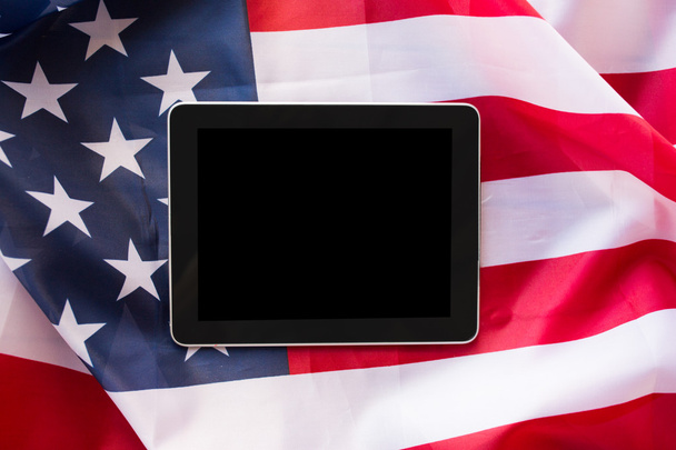 close up of tablet pc computer on american flag - Foto, Bild