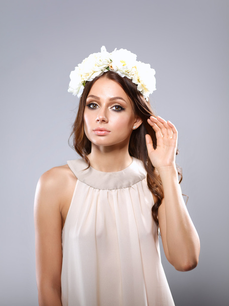 Portrait of a beautiful woman with flowers in her hair. Fashion - 写真・画像
