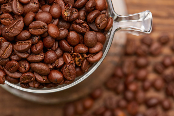 Fresh roasted coffee beans in cup  - Fotó, kép