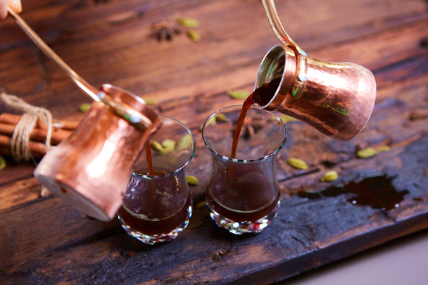 To pour arabic coffee in cups on wooden background. - Zdjęcie, obraz