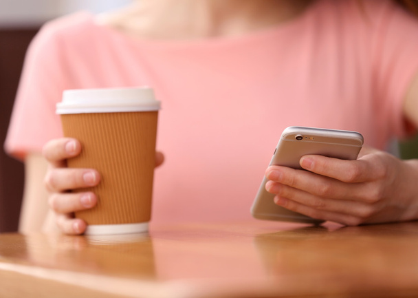 Woman with coffee and smartphone - Фото, зображення