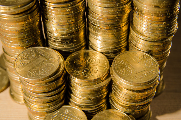 A bunch of hryvna coins on a wood table - Фото, зображення