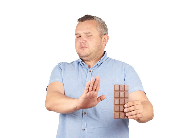 kövér ember hajlandó csokoládé. - Fotó, kép