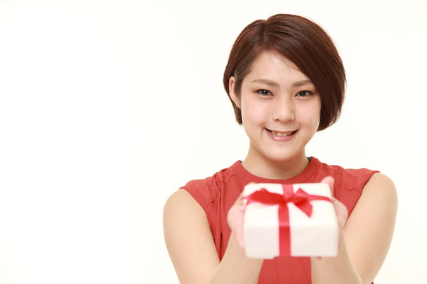 young Japanese woman offering a gift  - Foto, immagini