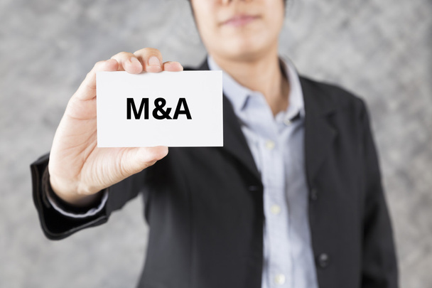 businessman presenting business card with word M&A - Photo, Image
