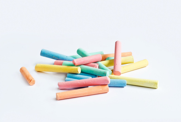 colorful chalk scattered on a white background - Foto, imagen