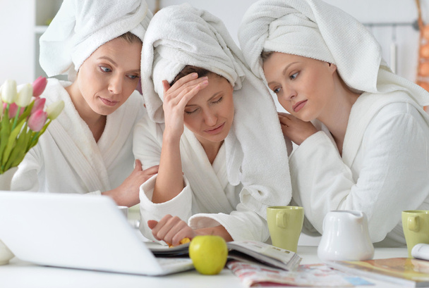 women wearing a white bathrobes with laptop - Φωτογραφία, εικόνα