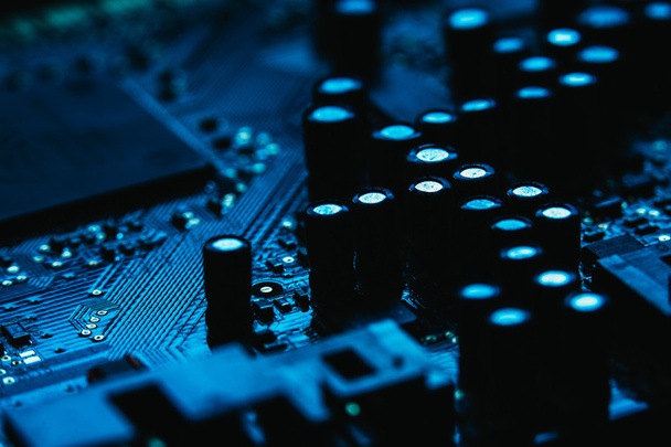 Computer motherboard closeup blue color on dark background - Foto, afbeelding