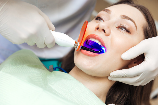 Close-up portrait of a female patient visiting dentist - Fotografie, Obrázek