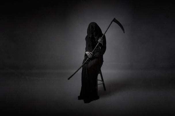 death sitting with arms on hand - 写真・画像