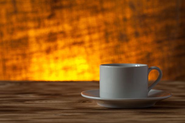 Cup of tea on light wooden table on blur jute background. Select - Fotografie, Obrázek