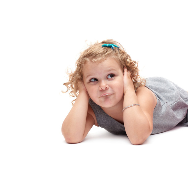 Young little girl lying over isolated white background - Photo, image