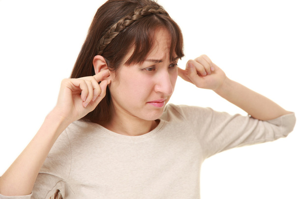 Young woman suffers from noise - Foto, afbeelding
