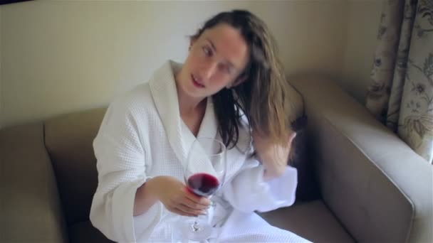 Young beautiful girl in a bathrobe - Materiał filmowy, wideo