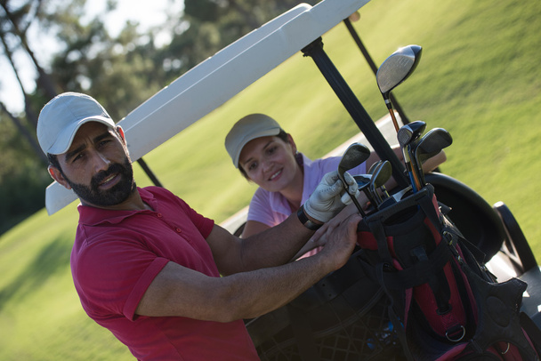 couple in buggy on golf course - Foto, afbeelding