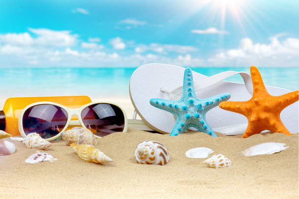 Summer background with starfish and accessories on sand beach - Photo, Image