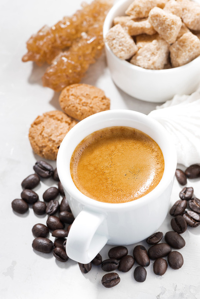 cup of espresso and sweet cookies on a white table, vertical - Foto, imagen
