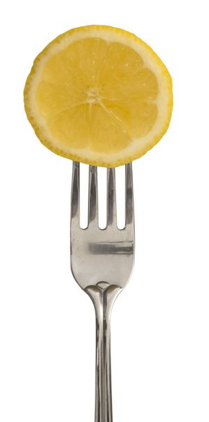 Slice of lemon on the fork - Fotó, kép