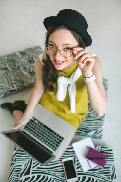 Young pretty businesswoman with laptop smiling over white backgr - Zdjęcie, obraz