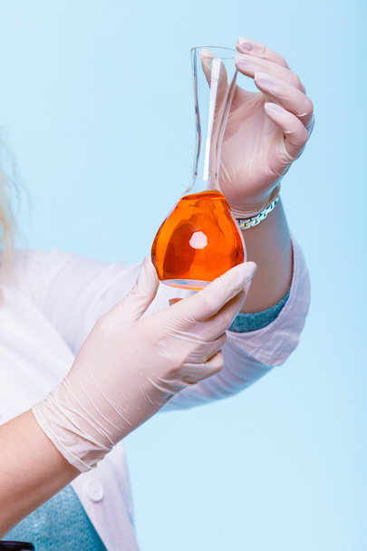 female chemistry student with glassware test flask. - Fotó, kép