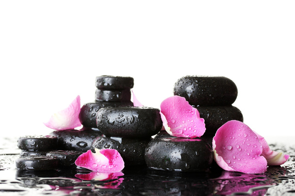 Spa stones with drops and rose petals on white background - Photo, image