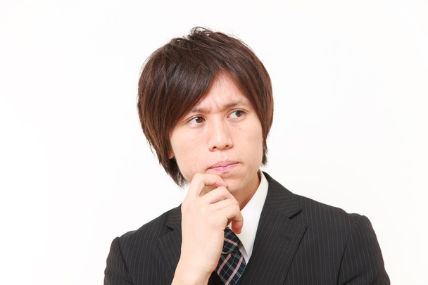 young Japanese businessman worries about something - Φωτογραφία, εικόνα
