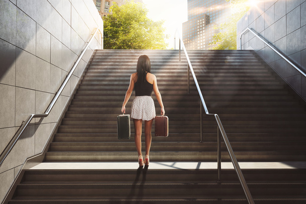 Woman with suitcases on stairs - Photo, Image