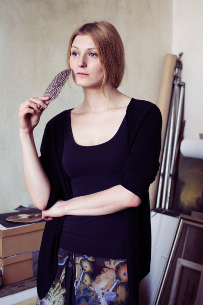 Portrait of a pensive woman with a quill  - Photo, Image