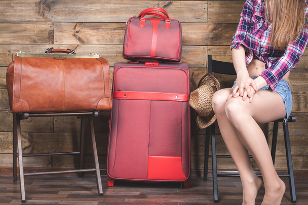 Young woman already packed her things, clothes at luggage, suitcase - Photo, image