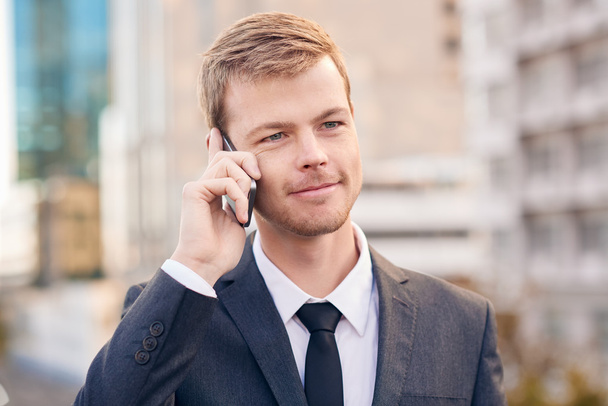 businessman talking on cellphone in city - Photo, image