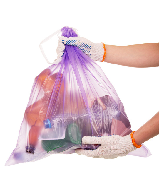 Full garbage bag in female hands isolated on white. - Фото, зображення