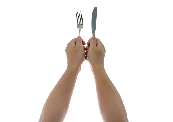 A knife and fork being held by man's hands. Isolated - Photo, Image