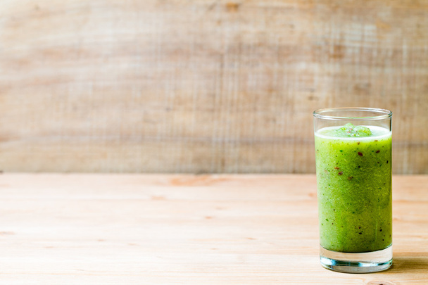 Healthy green smoothie in a glass on old wood. - Foto, Bild