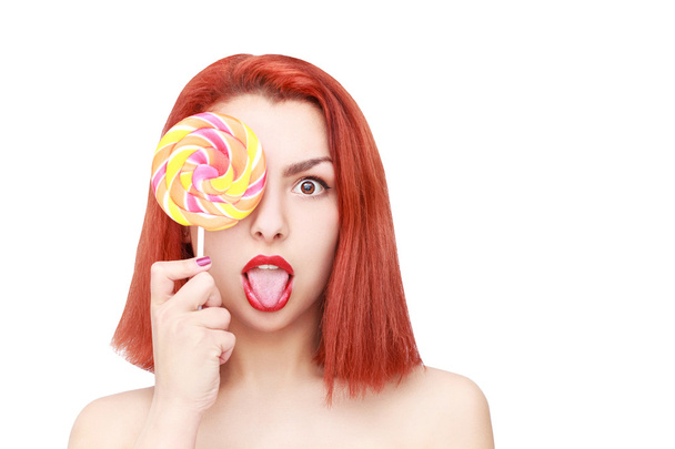 Lovely young woman with lolipop, on white background. - 写真・画像
