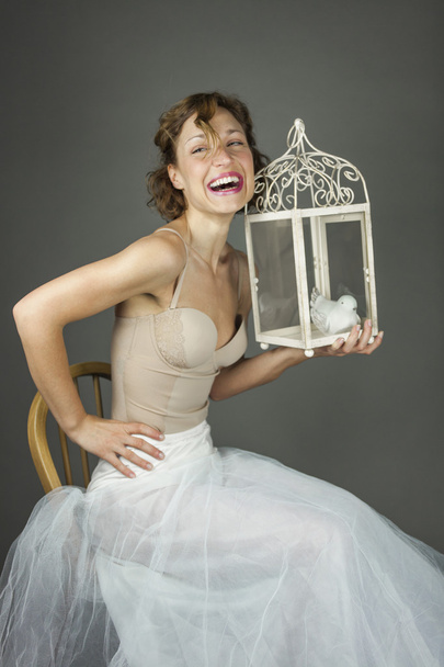 Young actress ballerina in a white tutu and a beautiful cage wit - Foto, Imagem