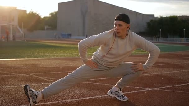 Young athletic man doing warm-up before exercise and jogging - Footage, Video