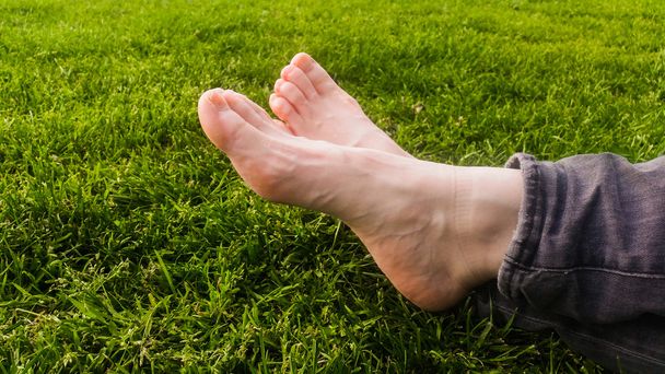 Barefoot on green grass under the sun light - Photo, Image